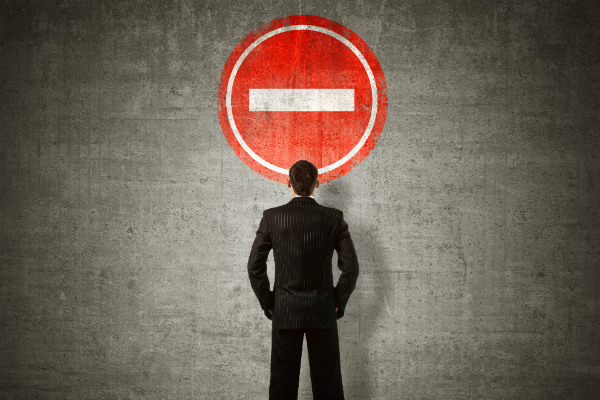 Man facing wall with sign