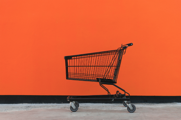 online shopping cart black trolley orange background