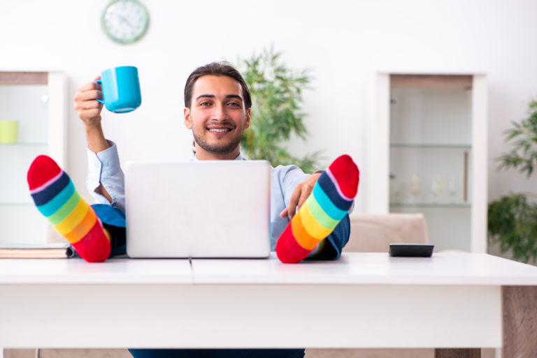 businessman in rainbow socks working from home