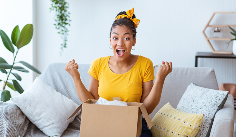 Excited woman opening package with next day shipping